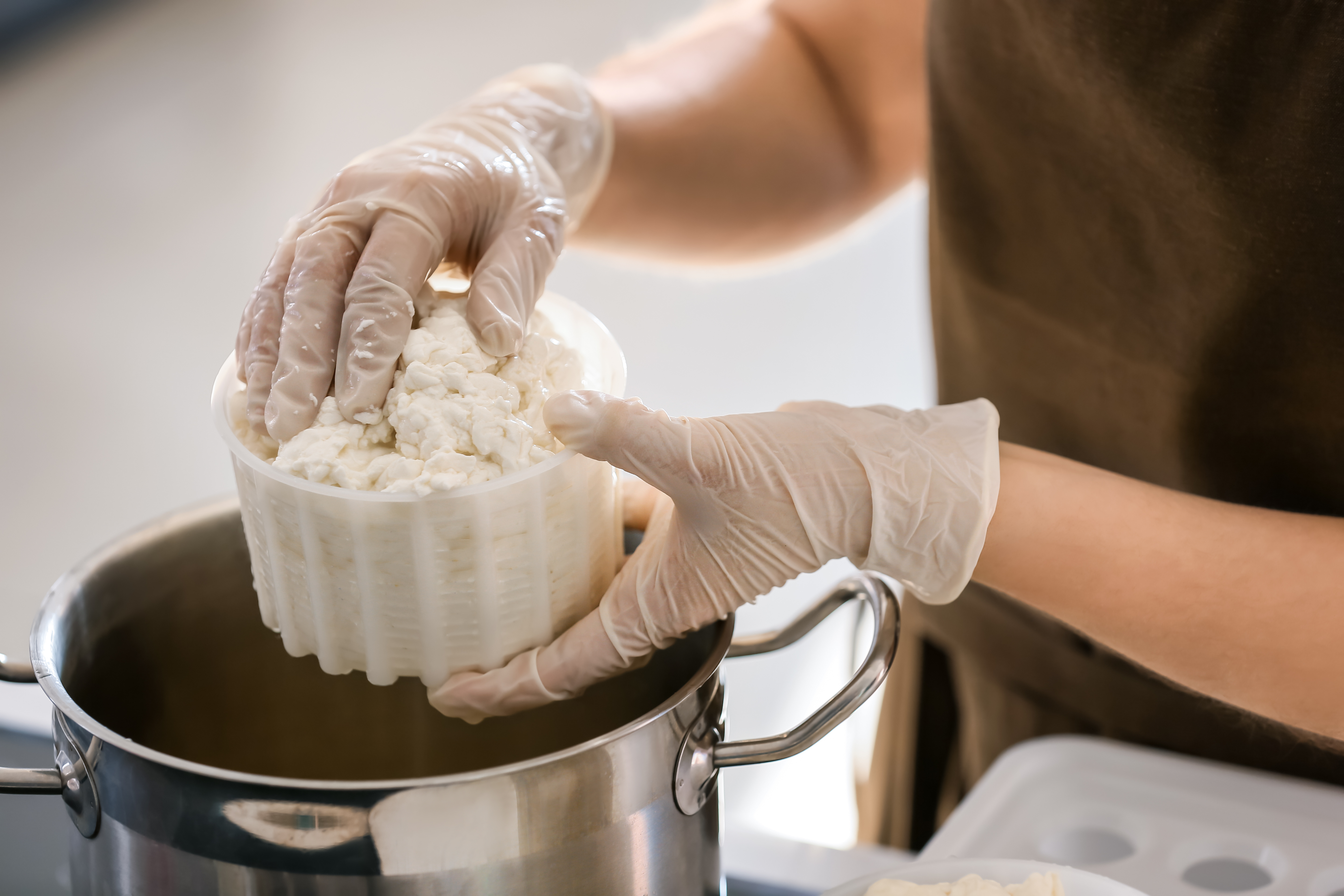 person making cheese