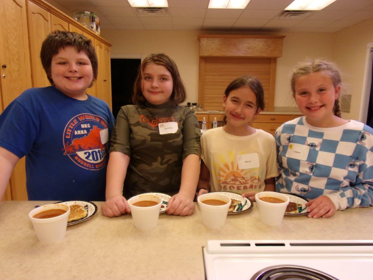 Children with chili and cornbread